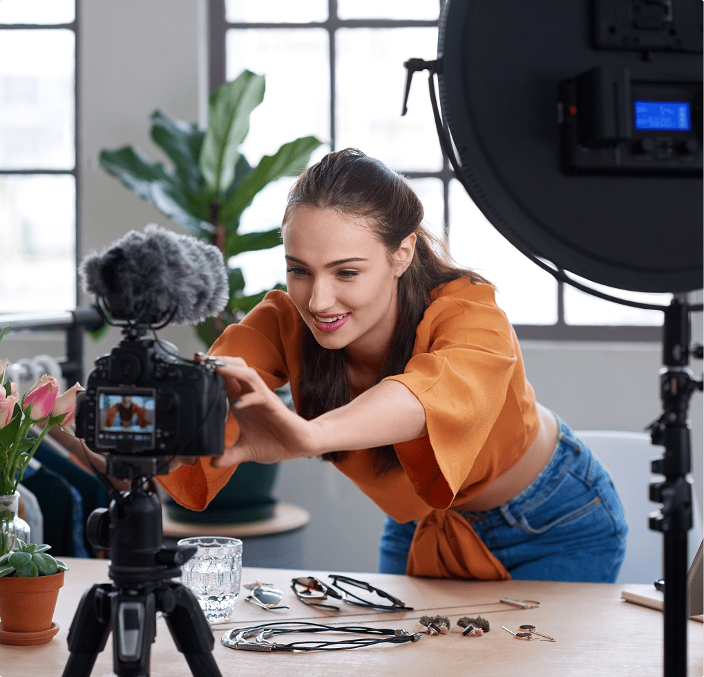 Woman sitting at a table with a camera in front of her